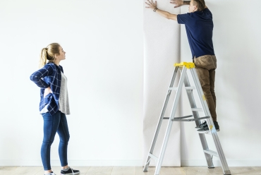 Couple choosing house wallpaper